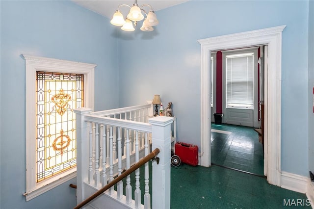 3815 N 20th St, Saint Louis, MO 63107 - corridor with an upstairs landing, a chandelier, and tile patterned floors