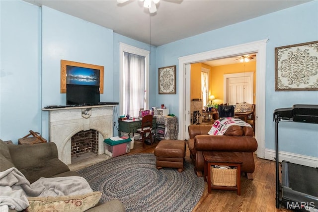 3815 N 20th St, Saint Louis, MO 63107 - living area with a ceiling fan, wood finished floors, and a fireplace