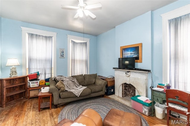3815 N 20th St, Saint Louis, MO 63107 - living area featuring wood finished floors, ceiling fan, and a fireplace