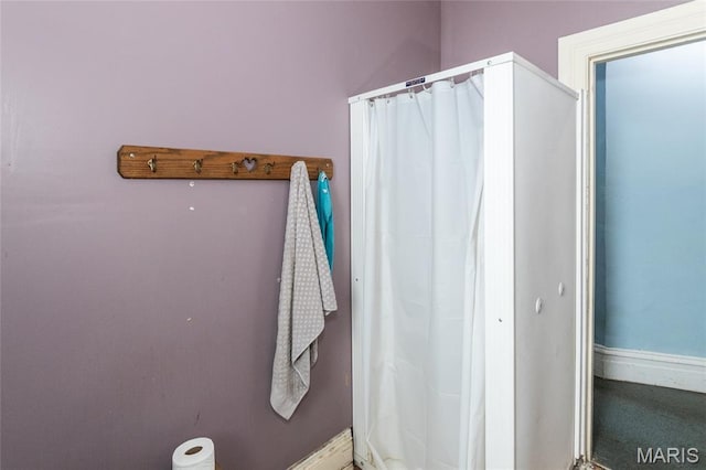 3815 N 20th St, Saint Louis, MO 63107 - bathroom featuring baseboards and a shower with shower curtain