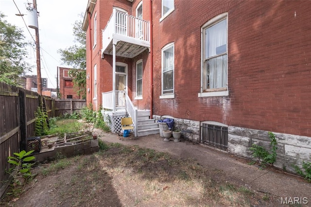 3815 N 20th St, Saint Louis, MO 63107 - back of property featuring brick siding and a fenced backyard