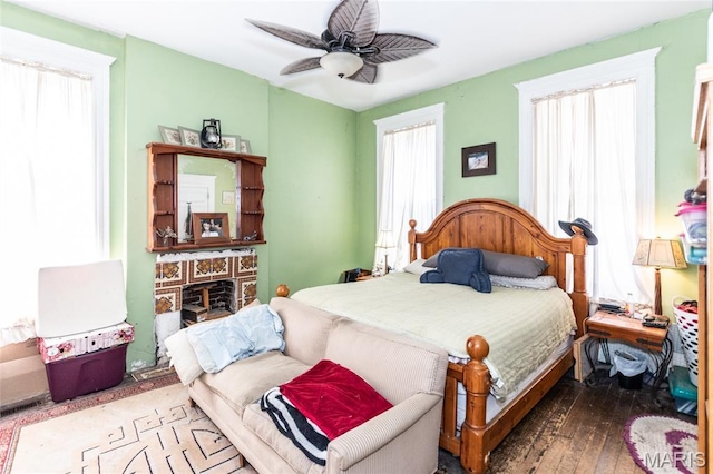3815 N 20th St, Saint Louis, MO 63107 - bedroom featuring hardwood / wood-style floors, a ceiling fan, and a fireplace