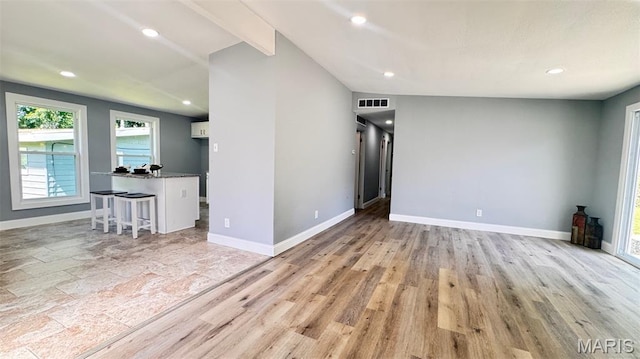 6822 Friarwood Dr, Saint Louis, MO 63134 - unfurnished living room with recessed lighting and light wood-style floors