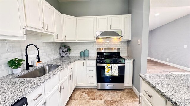 6822 Friarwood Dr, Saint Louis, MO 63134 - kitchen with stainless steel gas stove, ventilation hood, and white cabinetry