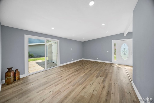 6822 Friarwood Dr, Saint Louis, MO 63134 - unfurnished living room with wood finished floors, recessed lighting, and lofted ceiling