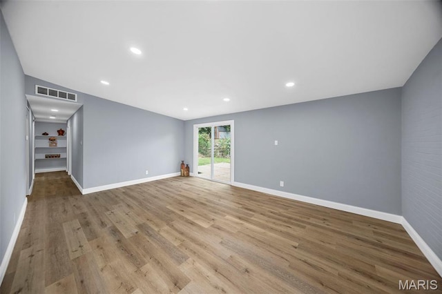 6822 Friarwood Dr, Saint Louis, MO 63134 - empty room with wood finished floors and recessed lighting