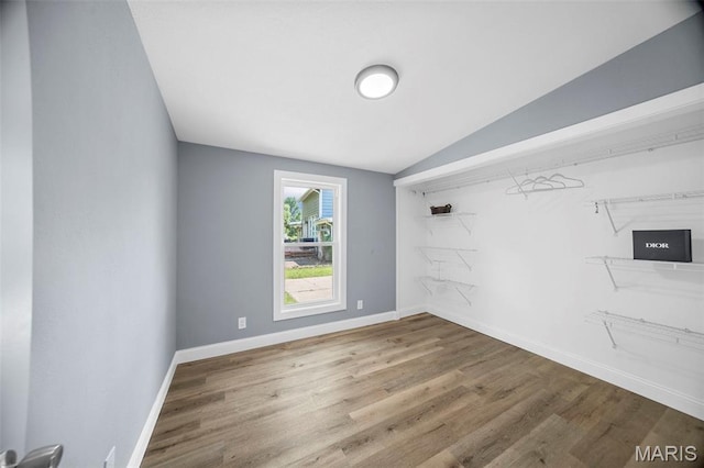 6822 Friarwood Dr, Saint Louis, MO 63134 - spare room with wood finished floors and lofted ceiling