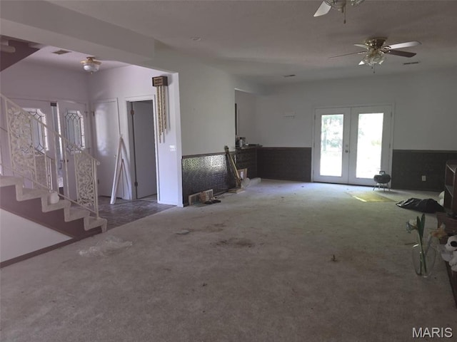 478 Batchtown Rd, Batchtown, IL 62006 - unfurnished living room featuring carpet, french doors, a wainscoted wall, ceiling fan, and stairway
