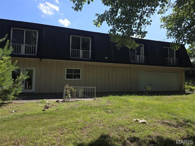 478 Batchtown Rd, Batchtown, IL 62006 - back of house featuring a lawn, a garage, board and batten siding, and a balcony