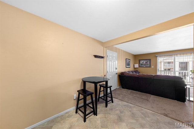 12114 Natural Bridge Rd Unit F, Bridgeton, MO 63044 - living area with baseboards and stone finish floors