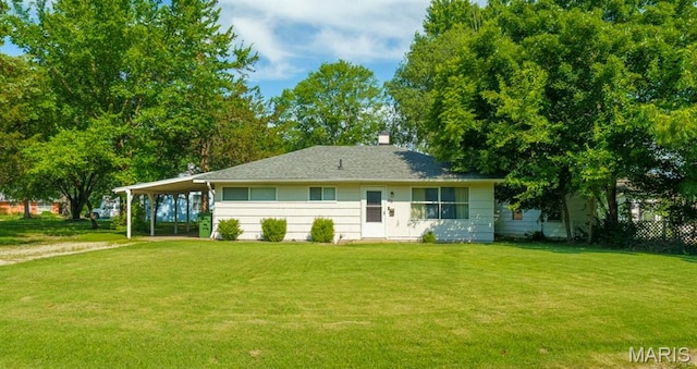 33 Southbrook Dr, Rolla, MO 65401 - back of house with a yard, an attached carport, and a chimney