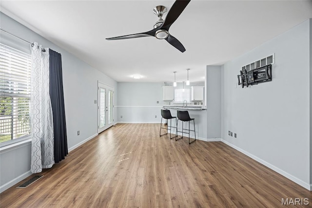 3112 Bentwater Pl, Saint Charles, MO 63301 - unfurnished living room with a ceiling fan and wood finished floors