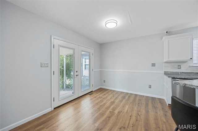 3112 Bentwater Pl, Saint Charles, MO 63301 - unfurnished dining area featuring light wood-style flooring and french doors