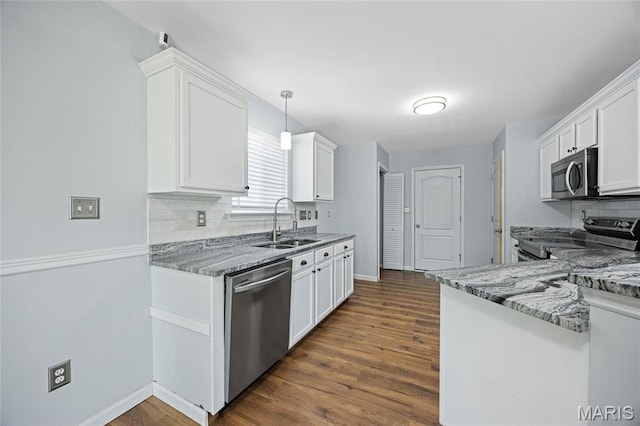 3112 Bentwater Pl, Saint Charles, MO 63301 - kitchen with appliances with stainless steel finishes, white cabinets, dark wood-style flooring, and backsplash