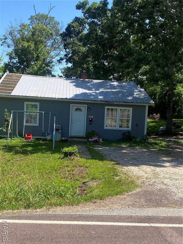 826 W Washington St, St James, MO 65559 - view of front of property featuring a metal roof, a front lawn, and a chimney