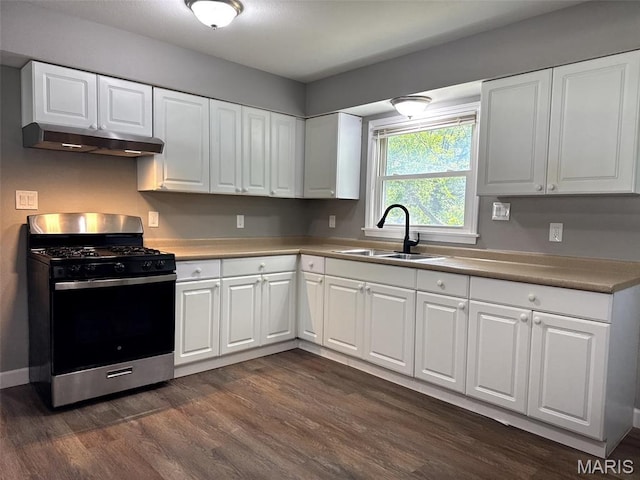 6613 Dunwold Dr, Saint Louis, MO 63134 - kitchen with stainless steel range with gas cooktop, under cabinet range hood, dark wood-style floors, white cabinets, and light countertops