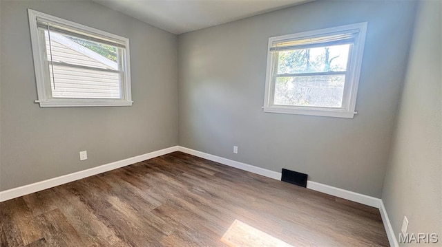 6613 Dunwold Dr, Saint Louis, MO 63134 - spare room featuring dark wood-style flooring