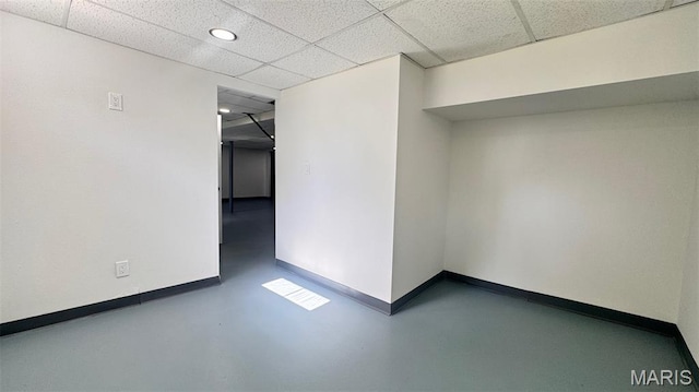 6613 Dunwold Dr, Saint Louis, MO 63134 - empty room featuring a drop ceiling, concrete floors, and recessed lighting