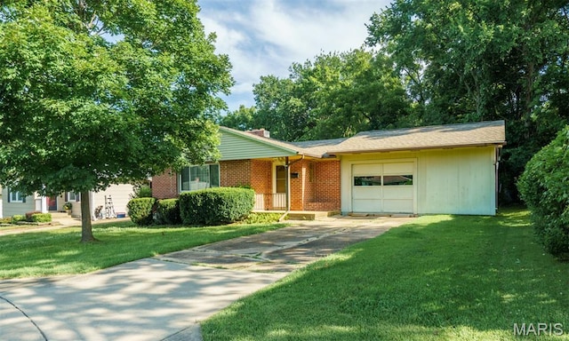 517 E 2nd St, Rolla, MO 65401 - view of front of house with a garage, driveway, a front lawn, and brick siding