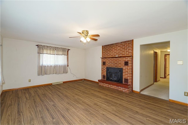 517 E 2nd St, Rolla, MO 65401 - unfurnished living room featuring ceiling fan, wood finished floors, and a brick fireplace