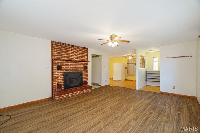 517 E 2nd St, Rolla, MO 65401 - unfurnished living room with a ceiling fan, wood finished floors, and stairs