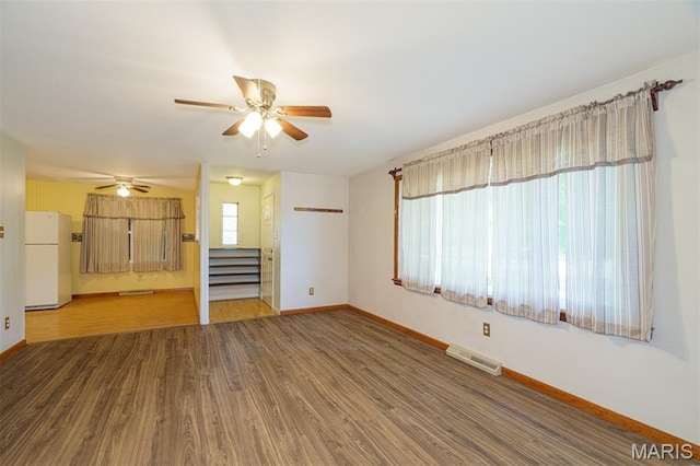 517 E 2nd St, Rolla, MO 65401 - unfurnished living room with a ceiling fan, wood finished floors, and stairs