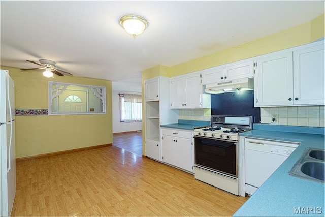 517 E 2nd St, Rolla, MO 65401 - kitchen with under cabinet range hood, white appliances, and white cabinetry