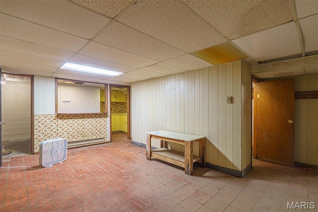 517 E 2nd St, Rolla, MO 65401 - finished basement featuring a drop ceiling, wood walls, and brick patterned flooring