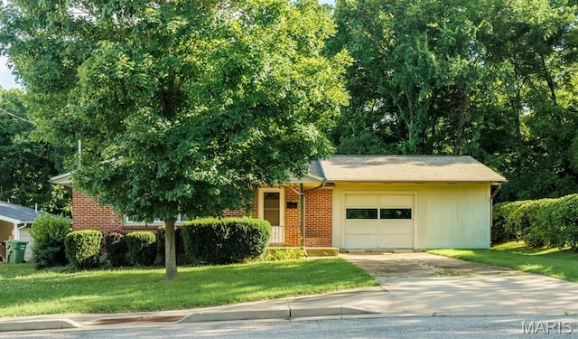 517 E 2nd St, Rolla, MO 65401 - view of front of home with an attached garage, concrete driveway, a front yard, and brick siding