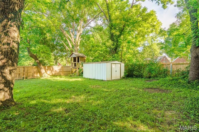 517 E 2nd St, Rolla, MO 65401 - fenced backyard with a storage unit and a playground