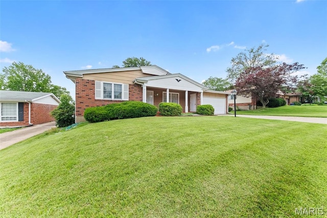 670 Gateswood Dr, Florissant, MO 63033 - view of front of house with a garage, driveway, a front yard, and brick siding