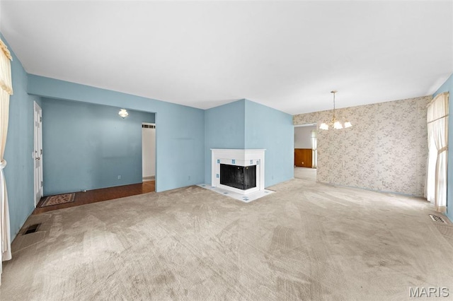 670 Gateswood Dr, Florissant, MO 63033 - unfurnished living room with a chandelier, carpet, a multi sided fireplace, and wallpapered walls