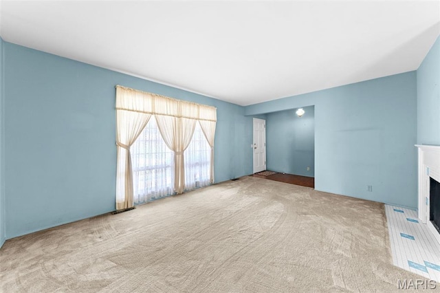 670 Gateswood Dr, Florissant, MO 63033 - unfurnished living room featuring carpet and a fireplace