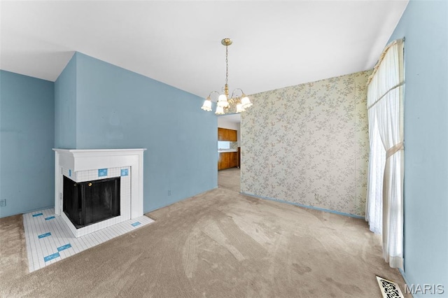 670 Gateswood Dr, Florissant, MO 63033 - unfurnished living room with carpet floors, a chandelier, and a tile fireplace