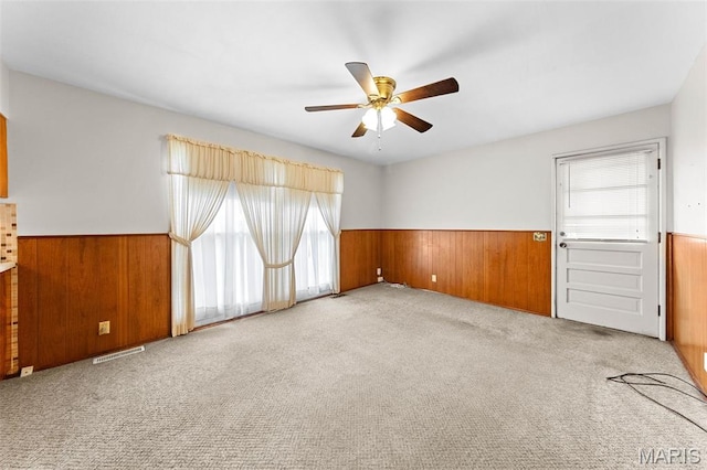 670 Gateswood Dr, Florissant, MO 63033 - carpeted spare room with wainscoting, wooden walls, and a ceiling fan