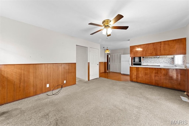 670 Gateswood Dr, Florissant, MO 63033 - unfurnished living room with ceiling fan, carpet, and a wainscoted wall