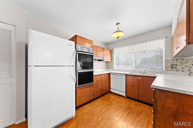 670 Gateswood Dr, Florissant, MO 63033 - kitchen with white appliances, light wood finished floors, and decorative backsplash