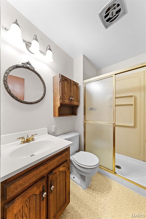 670 Gateswood Dr, Florissant, MO 63033 - bathroom featuring vanity, a stall shower, and tile patterned floors