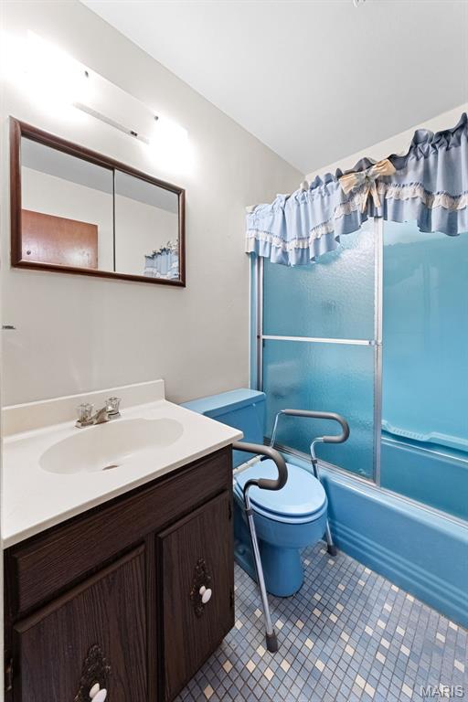 670 Gateswood Dr, Florissant, MO 63033 - bathroom featuring vanity, combined bath / shower with glass door, and tile patterned floors