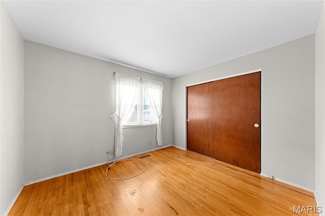 670 Gateswood Dr, Florissant, MO 63033 - unfurnished bedroom featuring a closet and wood finished floors