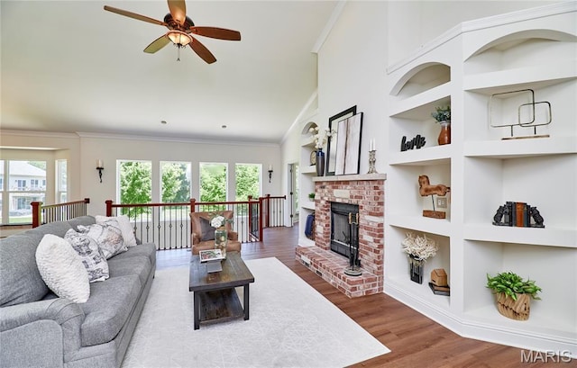 5 Tucker Manor Ct, Wentzville, MO 63385 - living area with built in features, ceiling fan, wood finished floors, crown molding, and a fireplace