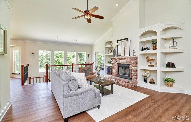 5 Tucker Manor Ct, Wentzville, MO 63385 - living area featuring a ceiling fan, healthy amount of natural light, wood finished floors, high vaulted ceiling, and ornamental molding