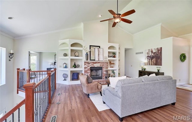 5 Tucker Manor Ct, Wentzville, MO 63385 - living room featuring high vaulted ceiling, a fireplace, wood finished floors, a ceiling fan, and ornamental molding
