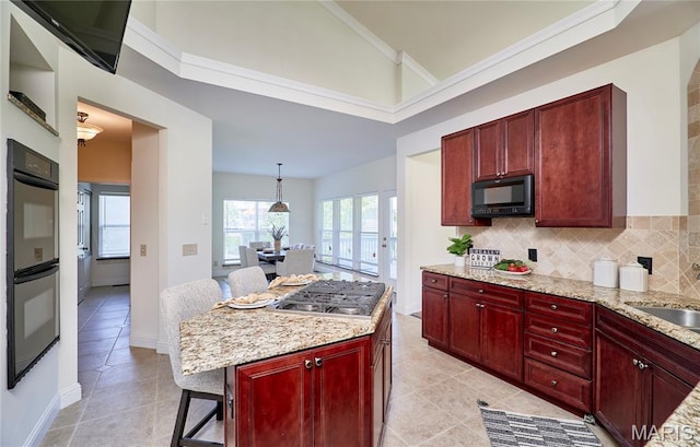 5 Tucker Manor Ct, Wentzville, MO 63385 - kitchen with appliances with stainless steel finishes, reddish brown cabinets, vaulted ceiling, light tile patterned floors, and tasteful backsplash