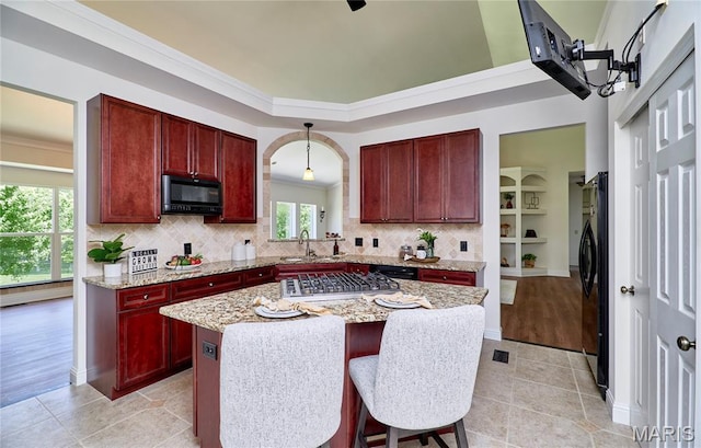 5 Tucker Manor Ct, Wentzville, MO 63385 - kitchen with reddish brown cabinets, black appliances, plenty of natural light, backsplash, and crown molding