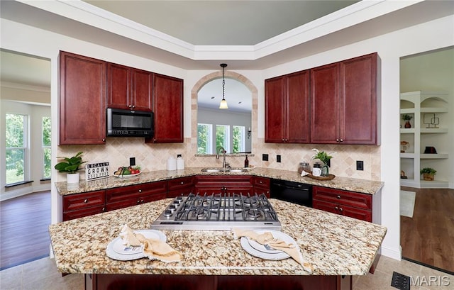 5 Tucker Manor Ct, Wentzville, MO 63385 - kitchen featuring dark brown cabinets, black appliances, crown molding, decorative backsplash, and a kitchen island