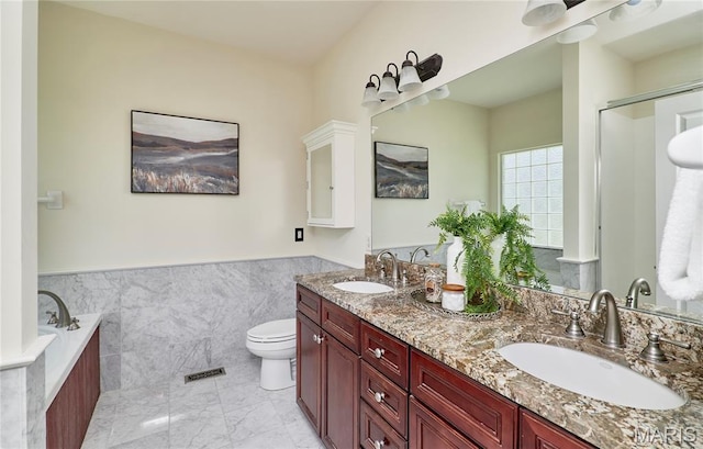 5 Tucker Manor Ct, Wentzville, MO 63385 - full bathroom with double vanity, a garden tub, a wainscoted wall, tile walls, and a shower with door