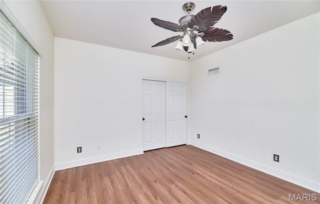 5 Tucker Manor Ct, Wentzville, MO 63385 - unfurnished bedroom with light wood finished floors, a closet, and a ceiling fan