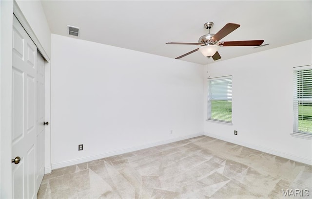 5 Tucker Manor Ct, Wentzville, MO 63385 - unfurnished bedroom with light colored carpet, multiple windows, a closet, and ceiling fan