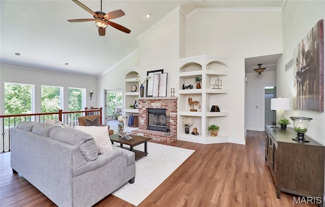 5 Tucker Manor Ct, Wentzville, MO 63385 - living room with a ceiling fan, high vaulted ceiling, wood finished floors, built in shelves, and a fireplace